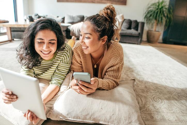 Two females watching iPad